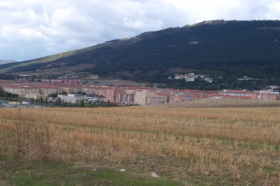Bloques de viviendas de Berriozar vistos desde el campo, con el monte detrás